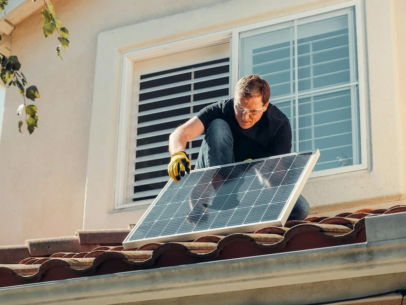 A modern home with solar panels installed on the roof